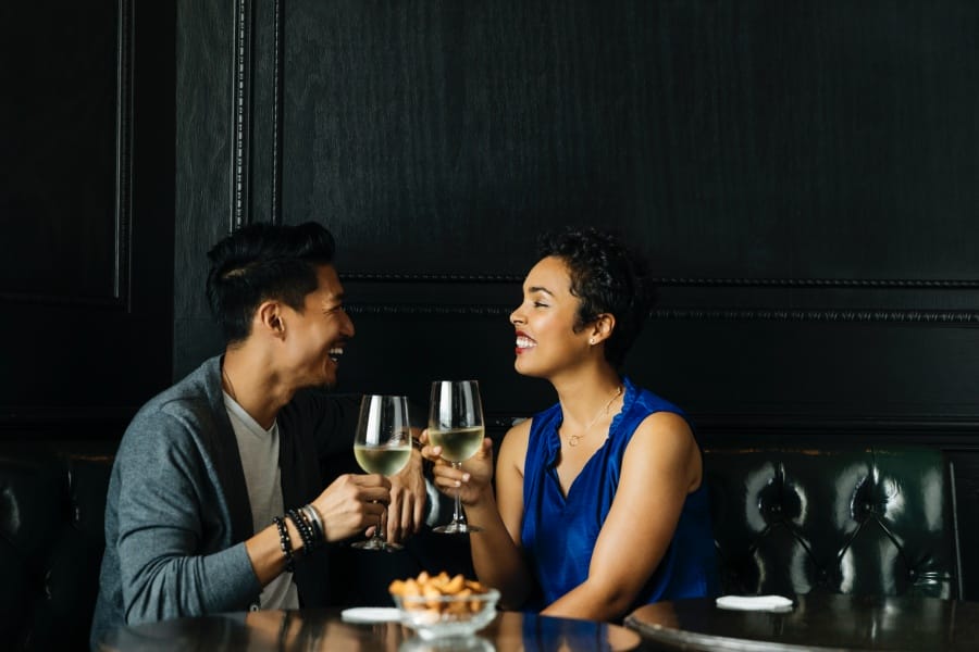 Couple toasting wine glasses at restaurant